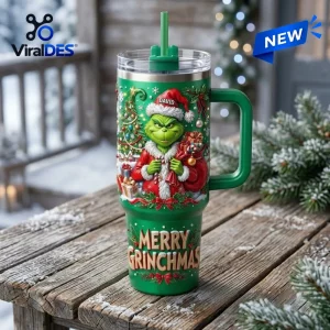Front view of a green Grinch Merry Grinchmas 40oz tumbler with a handle on a wooden table.