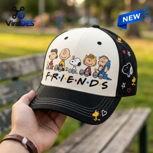 Close-up of a Peanuts Snoopy Friends black baseball cap held in hand.