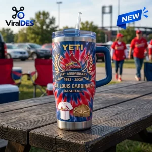 Front view of a St. Louis Cardinals 144th Anniversary YETI tumbler with tie-dye pattern on a wooden picnic table.