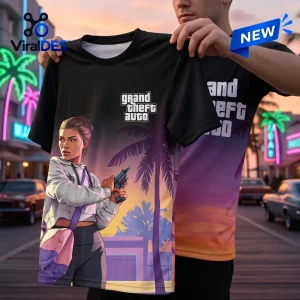 Man holding up a Grand Theft Auto VI Gradient T-Shirt featuring a sunset palm tree and armed character graphic.