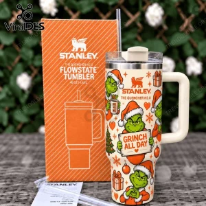 The Grinch Holiday 40oz Stanley FlowState Tumbler featuring green Grinch characters, Christmas motifs, and orange box.