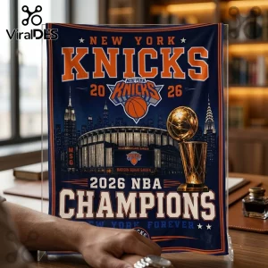 New York Knicks 2026 Champions navy fleece blanket featuring Madison Square Garden, the Larry O'Brien trophy, and text.