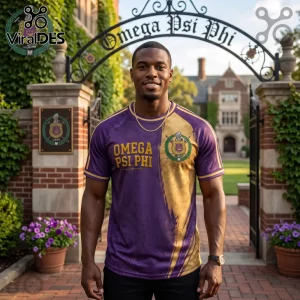 Premium Omega Psi Phi Purple and Gold Shirt worn by a man standing before a fraternity gate with ivy-covered brick pillars.