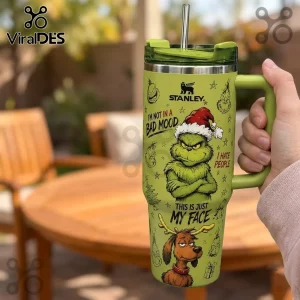 Stanley The Grinch Green 40oz Flowstate Tumbler featuring Grinch graphics, holiday text, and a matching green handle.