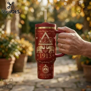 Delta Sigma Theta 40oz Crimson Gold Tumbler with Greek letters, elephant imagery, and 1913 text held by a hand outdoors.