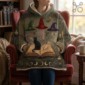 Witchcraft Cat and Spellbook Hooded Blanket featuring a black cat, vintage open book, and witch hats on an olive green fabric.