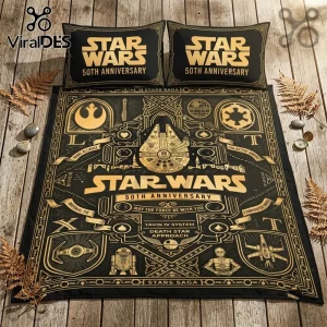 Star Wars 50th Anniversary Millennium Falcon duvet set in black and gold on a rustic wood surface with matching pillows.