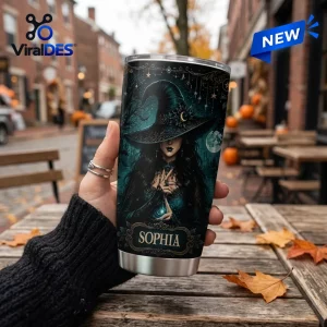 Close-up of a custom name tumbler featuring a witch illustration and Salem-inspired artwork held outdoors.