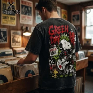 Green Day x Snoopy Rock Band shirt on a person in a music store, featuring a mohawk Snoopy graphic and red punk lettering.