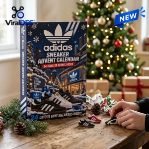 Front view of an Adidas Sneaker Advent Calendar with hands holding miniature shoes on a wooden table.
