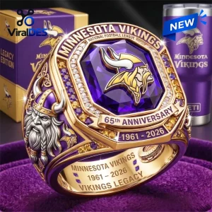 Closeup of a gold and purple Minnesota Vikings 65th Anniversary Championship Ring with a large central purple stone.
