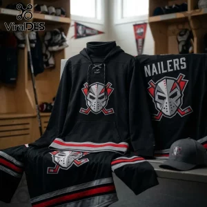 Wheeling Nailers ECHL Alternate Hockey Mask Hoodie in black with red and white accents, displayed in a locker room setting.