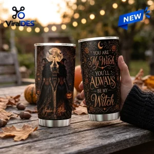 Hand holding a witch sisters Halloween custom name tumbler with silhouette illustration and seasonal text.