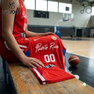 Puerto Rico Basketball 2026 FIBA Women World Cup red jersey with white lettering and number 00, displayed on a wooden bench.