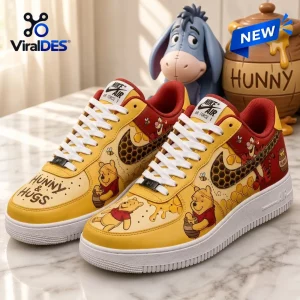 Winnie the Pooh Tigger Nike Air Force 1 Sneakers in yellow and red with honey pot graphics and text on a marble surface.