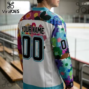 Cincinnati Cyclones Floral Pride Hockey Jersey featuring a white base, multicolored floral sleeves, and custom numbering.