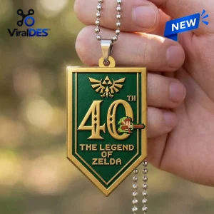 The Legend of Zelda 40th Anniversary Acrylic Car Ornament featuring a green shield design with gold trim and pixel art.