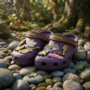 Elvis Presley Purple Crocband Clog With Charms featuring a guitar, crown, microphone, and vintage car on a pebble ground.