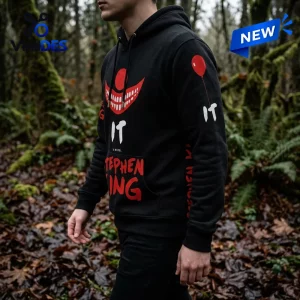 Side view of a black Stephen King IT 40th Anniversary Pullover Hoodie featuring red graphics and white text in a forest.