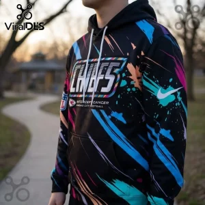 Kansas City Chiefs 2026 Crucial Catch Black Pullover Hoodie featuring multi-colored paint splatter patterns and team logos.