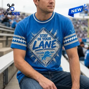 Front view of a blue t-shirt featuring a street sign graphic with the text Stay In Your Lane and a lion silhouette.