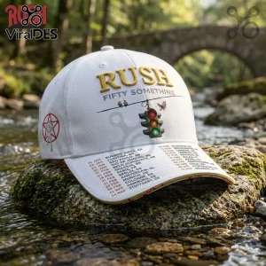 Rush Fifty Something 2027 Tour white baseball cap featuring gold embroidery, a traffic light graphic, and tour dates.