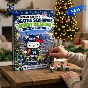 Front view of a Seattle Seahawks Advent Calendar with a hand holding a character charm in front of a Christmas tree.