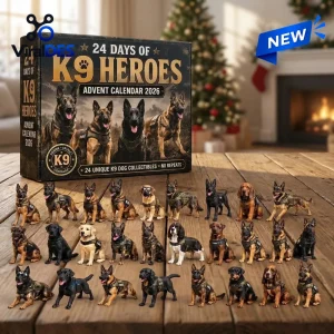 Front view of K9 Heroes Advent Calendar 2026 box with twenty-four dog figurines arranged on a wooden table.
