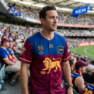 Man wearing a maroon and blue Brisbane Lions 2026 AFL Premiers Baseball Jersey in a stadium setting.