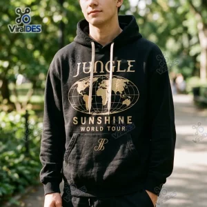Front view of a person wearing a Jungle Sunshine World Tour Merchandise Hoodie featuring a globe and gold text.