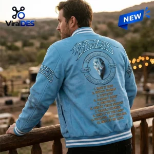 Rear view of a man wearing the Eagles 50th Anniversary Blue Varsity Jacket outdoors.