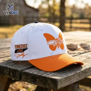 Front view of Tennessee Volunteers Dolly Parton Tribute Cap featuring an orange butterfly and text on a white and orange hat.