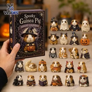 Hand holding a Spooky Guinea Pig Halloween Countdown Advent Calendar box next to a collection of tiny guinea pig figurines.
