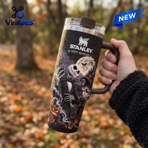 Hand holding Stanley Nightmare Before Christmas 40oz Tumbler with graveyard scene and full moon.
