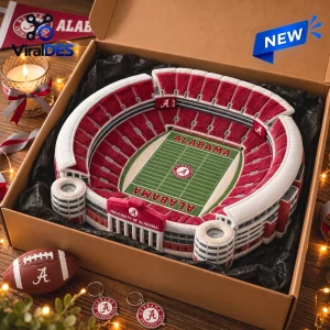 Top view of a plush stadium pillow in a gift box with a football and keychains.