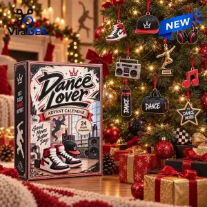 Front view of the Dance Lover Advent Calendar box beside a decorated Christmas tree with themed ornaments.