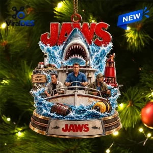 Front view of the Jaws Amity Island Christmas Holiday Ornament hanging on a pine tree branch with string lights.