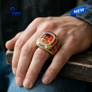 Closeup of a hand wearing the Def Leppard 2027 Tour Championship Ring with a red center stone.