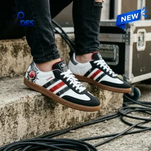 Low angle view of person wearing Five Finger Death Punch Adidas Samba Shoes with custom skull graphic.