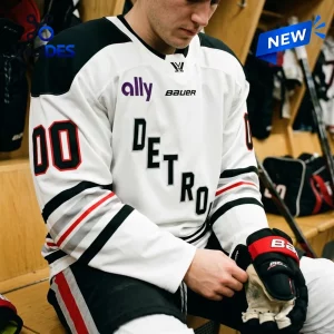 Player wearing PWHL Detroit 2026 Away Custom Hockey Jersey in locker room.
