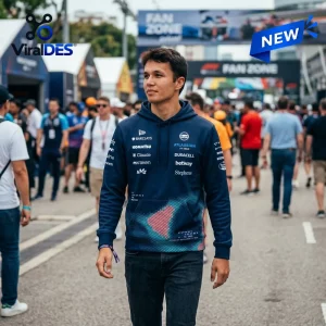 Front view of a person wearing a navy blue Williams F1 Team Hoodie while walking through a crowded outdoor event area.