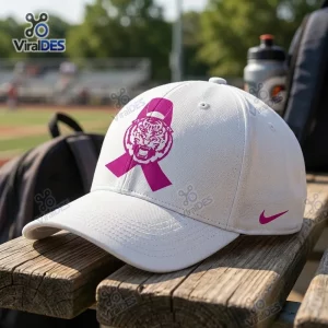 Front view of Louisiana State University Tigers pink ribbon baseball cap resting on a wooden bench.