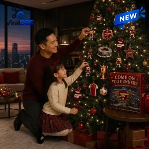Father and daughter hanging ornaments on an Arsenal FC 2026 Christmas Football Advent Calendar tree.