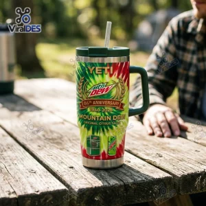 Front view of Mountain Dew 86th Anniversary Tumbler Cup with handle on wooden picnic table.