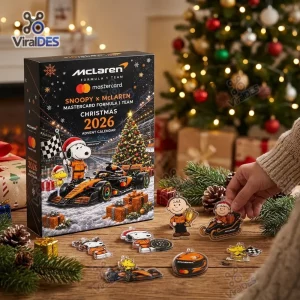 Front view of the Snoopy x McLaren Formula 1 Christmas 2026 Advent Calendar box and acrylic charms on a wooden table.