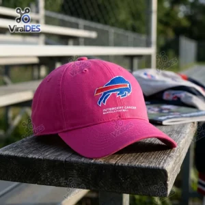 Front view of an NFL Crucial Catch Buffalo Bills pink cap resting on a wooden bench.