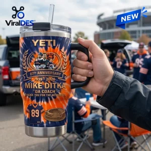 Hand holding a Mike Ditka Chicago Bears 87th Anniversary Tumbler with handle outdoors.