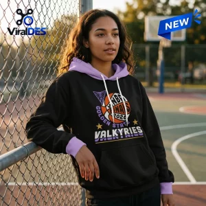 Woman leaning against a chain-link fence wearing a black and purple Golden State Valkyries 2026 WNBA Finals Pullover.