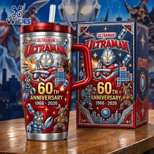 Front view of an Ultraman 60th Anniversary 1966-2026 Tumbler Cup with a handle, straw, and matching box on a wooden table.