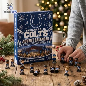 Person holding miniature player figurines next to an Indianapolis Colts 2026 Advent Calendar box on a wooden table.